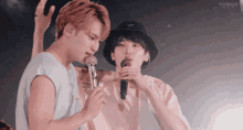 two boys singing into microphones with the word wow on the bottom