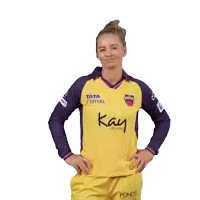 a woman is wearing a yellow and purple shirt that says " kay beauty "