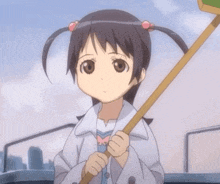 a little girl in a white coat is holding a stick