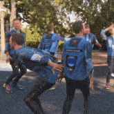 a group of men wearing blue jackets that say space force on them