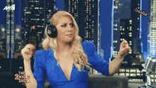 a woman wearing headphones is dancing in front of a microphone on the 2 night show