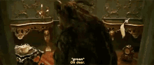 a frog with horns is standing next to a table with a feather on it and says groan oh dear .