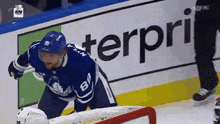 a hockey player in a blue jersey with the number 8 on it