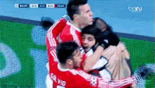 a group of soccer players are hugging and one of them has the number 10 on his shirt