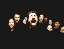 a group of people are standing in a dark room