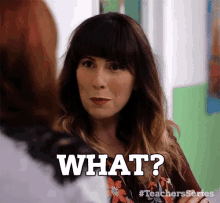 a woman with bangs is talking to another woman and says what ?