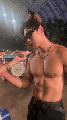 a shirtless man wearing sunglasses and a necklace is being touched by a woman