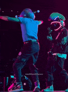 a man is dancing on a stage with the words swallowedthesea in the corner