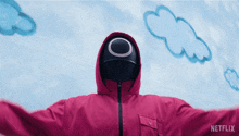 a person wearing a pink jacket with a hood and a black mask with a circle on it