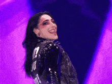a woman wearing a black leather jacket with the word juif on the back