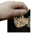 a close up of a person 's hand holding a picture of a man 's face .