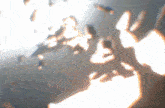 a blurry image of a person 's shadow on a wall with a light shining through it