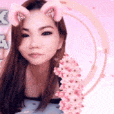 a woman with cat ears on her face and flowers in front of her