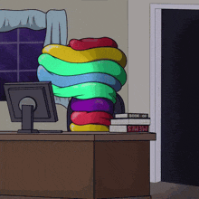 a book of memes sits on a desk next to a stack of books