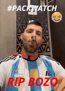 a man wearing a blue and white striped shirt is smoking a cigarette