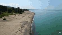 an aerial view of a beach with a dji logo on the bottom
