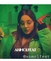 a woman wearing glasses and a green jacket with the words anmolfeat @anmolfeat on the bottom