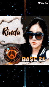 a girl wearing sunglasses and a hoodie with the words rindu and base 21 below her