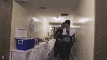 two men are walking down a hallway with one wearing a jersey that says 666