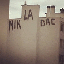 a building with the words `` la nik bac '' written on the side of it .