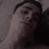 a close up of a young man 's face with a piercing in his nose