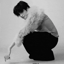 a black and white photo of a man kneeling down with the caption uppoom_06