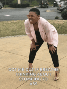 a woman in a pink jacket is kneeling on the sidewalk with a caption that reads got me out if breathe