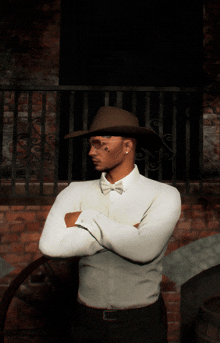 a man with his arms crossed wearing a cowboy hat and bow tie