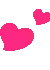 two pink hearts are floating in the air .