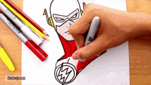 a person is drawing a picture of the flash with markers