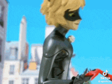cat noir from miraculous ladybug is standing in front of a city holding a red object .