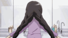 a girl in a purple shirt is braiding her hair in a bathroom