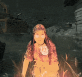 a woman wearing a hat and a shirt that says ' a ' on it sits in a field