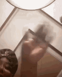 a person is taking a picture of themselves in a mirror while wearing a hat .