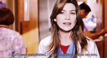 a woman in a lab coat is standing in a hallway and says i don 't need complicated .