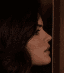 a close up of a woman 's face looking at a man