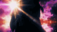 a person is standing in front of a purple sky with the sun shining through it