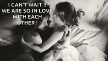 a couple of women are kissing on a bed .