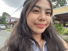 a woman with long hair is smiling for the camera