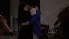 a man and a woman kissing in a dark room