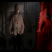 a man with blood on his face is smiling and looking at the camera