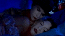 a man is kissing a woman on the neck while they are sleeping .