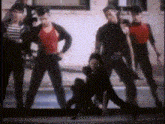 a group of people are standing next to each other in front of a building .