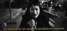 a black and white photo of a person with a caption that says hiç kimse onlar