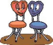 two chairs with hearts on them are sitting on a table .