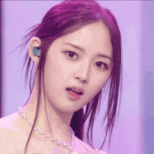 a close up of a girl with purple hair and a necklace