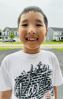 a young boy wearing a t-shirt that says " let 's party "