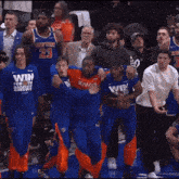 a group of basketball players wearing new york jerseys