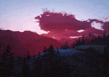 a sunset over a mountain range with trees and rocks in the foreground
