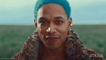 a man with blue hair is wearing a leopard print coat and earrings